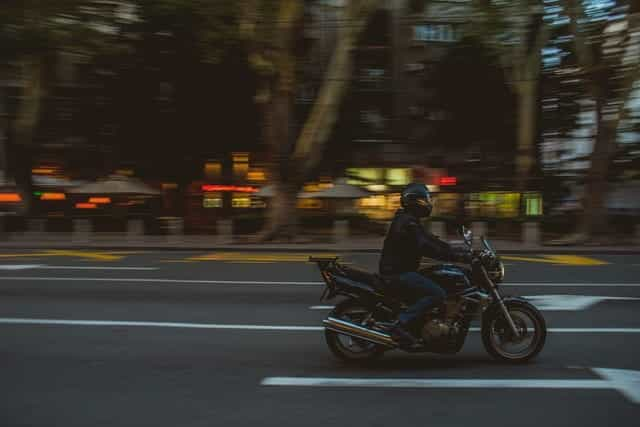 A man rides a motorcycle through the streets of Beograd, Serbia.