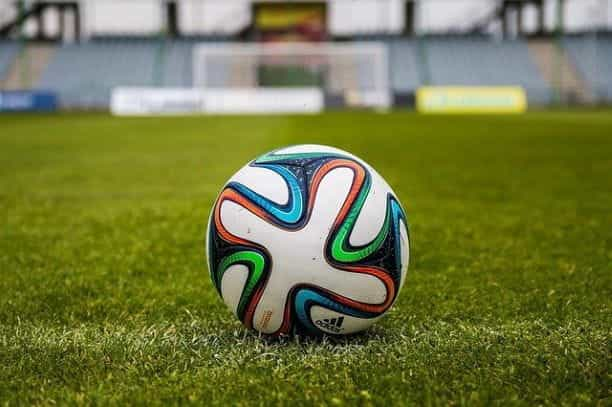 A football on a grass pitch.