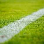 Closeup of a line on a football pitch.