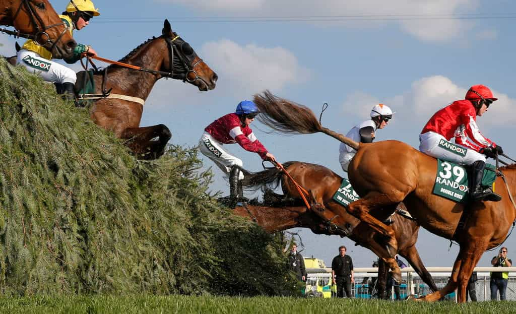 Grand National runners clearing one of Aintree’s famous obstacles.