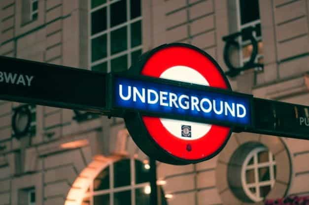 A lit-up London underground street sign.