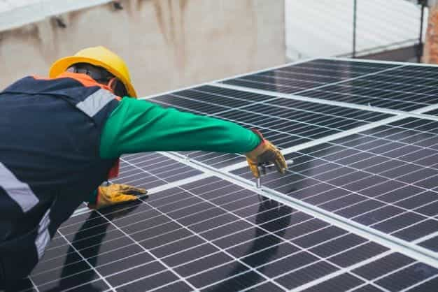 A worker setting up a solar panel.