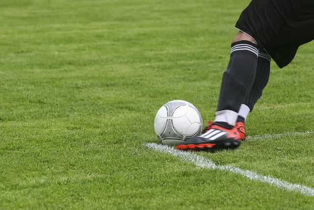 A footballer about to kick the ball.