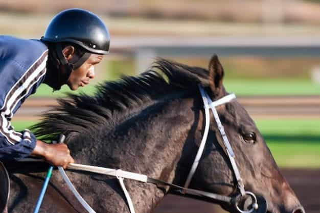 A jockey riding a racehorse.