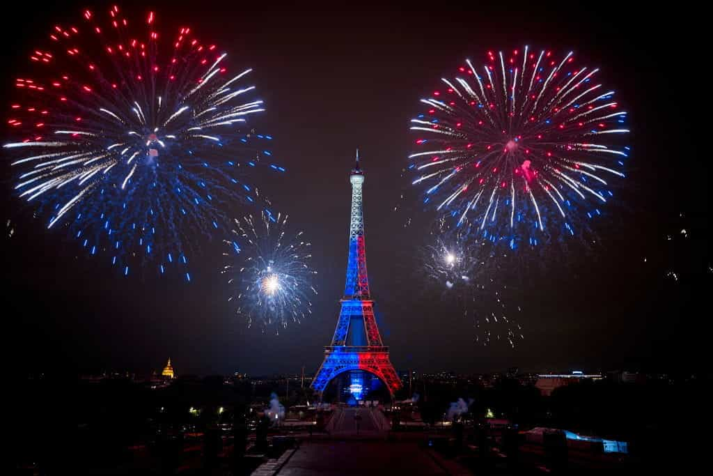 Fireworks explode above the Eiffel Tower in Paris.