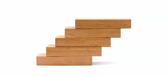 Wood blocks stacked on top of each other to create an upward trajectory.