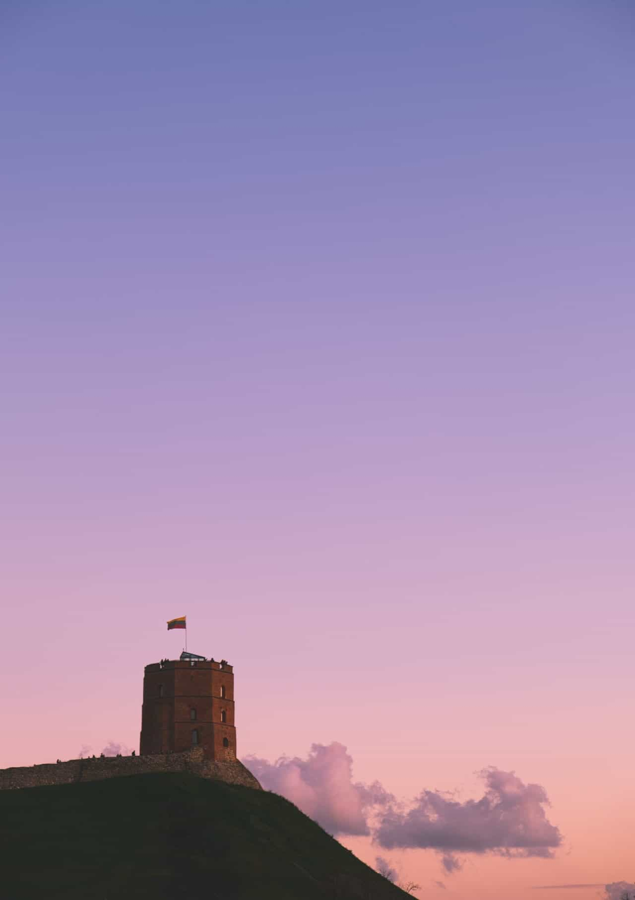 Castle on a hill with pink sunset.