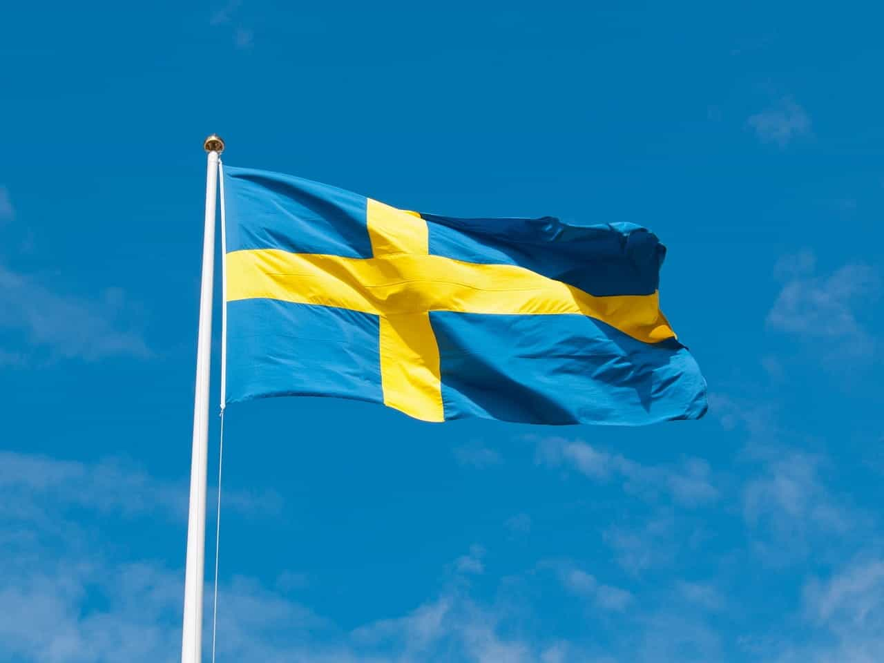 Swedish flag fluttering in the breeze on a sunny day.