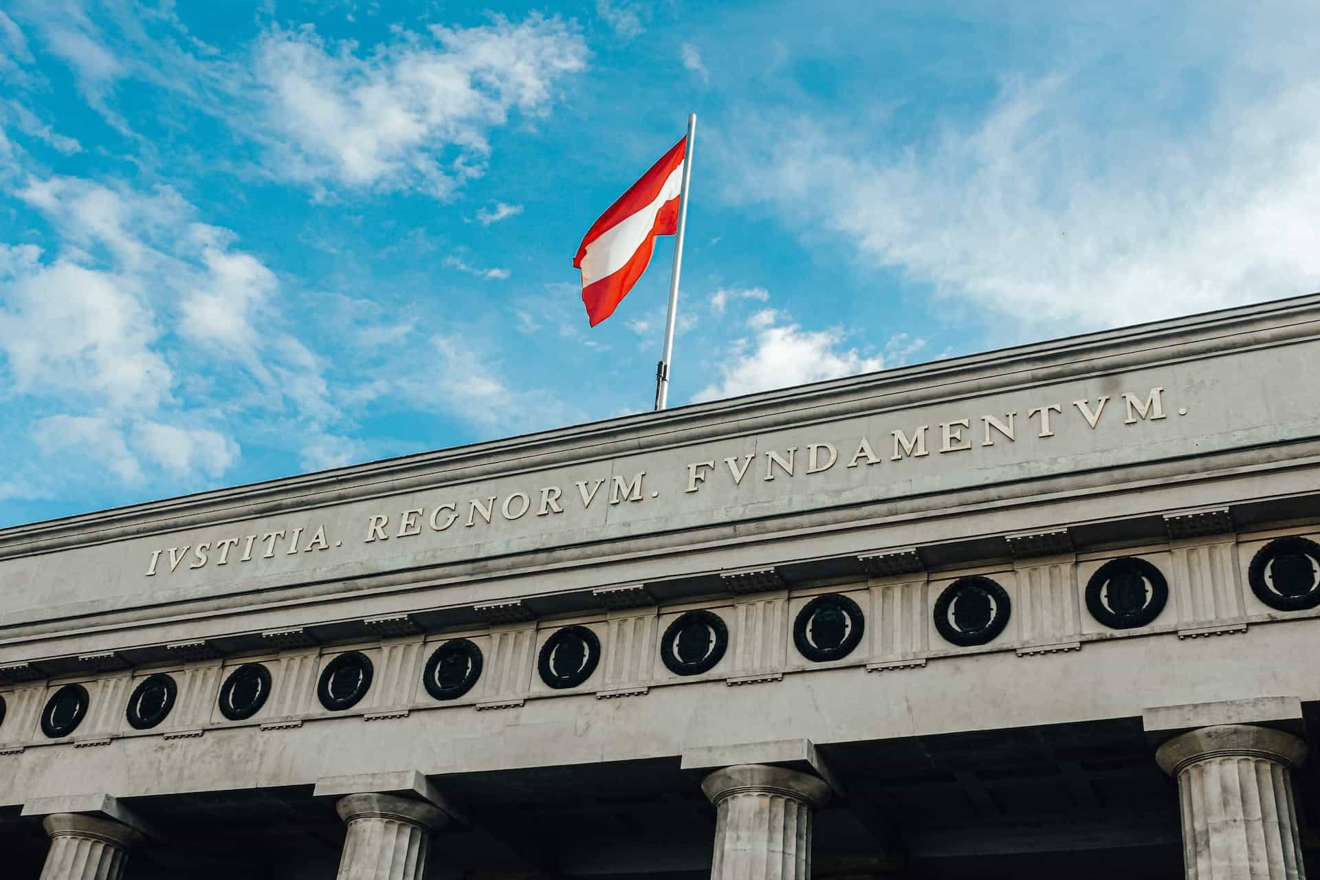 Austrian flag flying over the Hofburg Palace in Vienna.