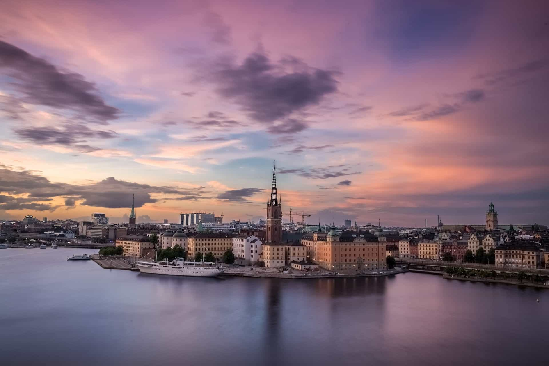 The Swedish waterfront showing a yacht and other buildings by the bay.