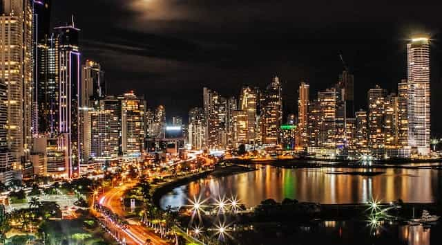 Brightly lit buildings in Panama City by night.