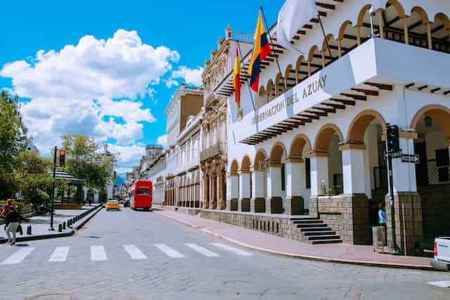 A building in Cuenca, Ecuador, brandishes two flags.