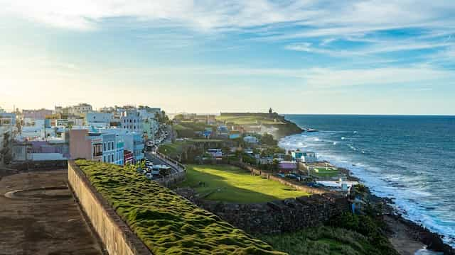 Colorful buildings on a brightly lit coastline at San Juan, Puerto Rico.