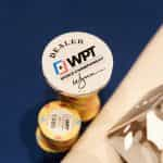 WPT branded poker chips and a dealer button.